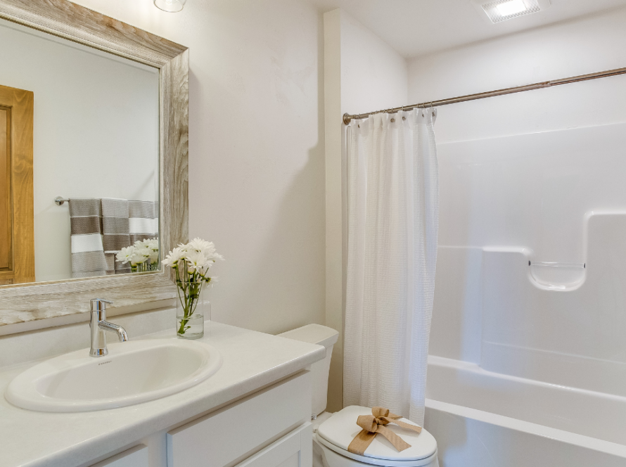 A sparkling, newly remodeled bathroom in Toronto featuring a modern vanity, stylish fixtures, and well-placed lighting.